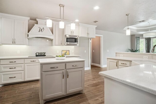 7312 Bishop Ct, Fort Worth, TX 76179 - kitchen featuring black appliances, a center island, a sink, dark wood-style flooring, and crown molding
