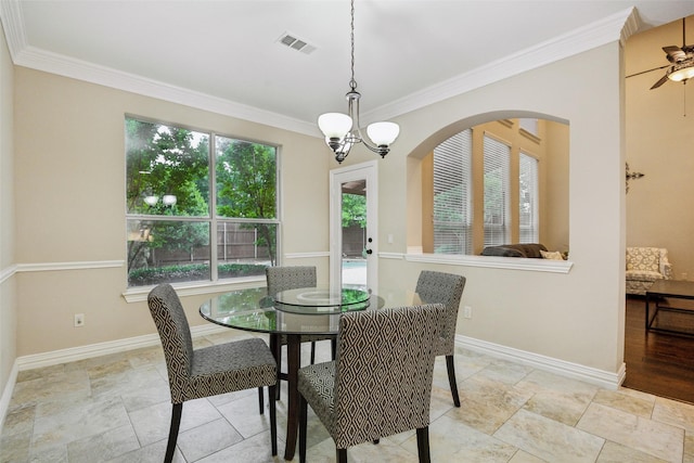 dining area featuring crown molding, baseboards, ceiling fan with notable chandelier, and visible vents