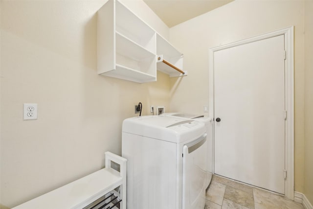 laundry room featuring baseboards, laundry area, and washer and clothes dryer