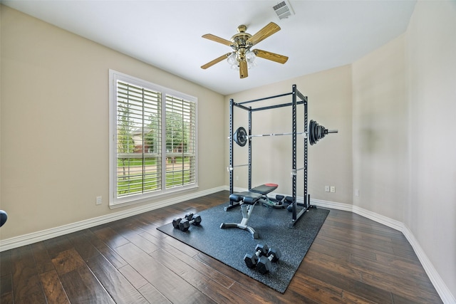 exercise area with baseboards, ceiling fan, wood finished floors, and visible vents