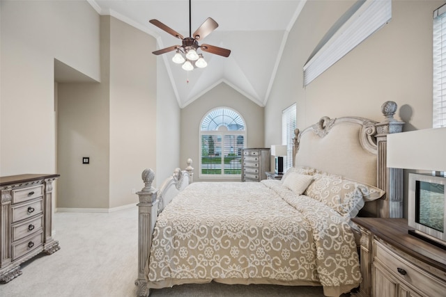 bedroom with crown molding, light carpet, baseboards, high vaulted ceiling, and a ceiling fan