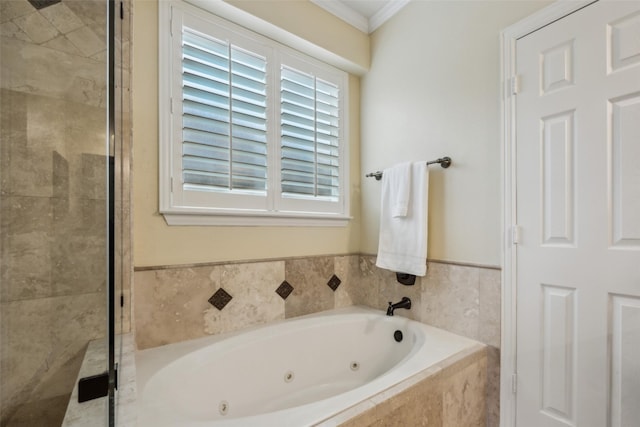 full bath with ornamental molding, a shower stall, and a tub with jets