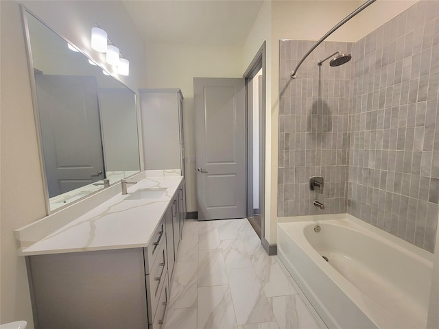 bathroom featuring vanity, marble finish floor, and washtub / shower combination