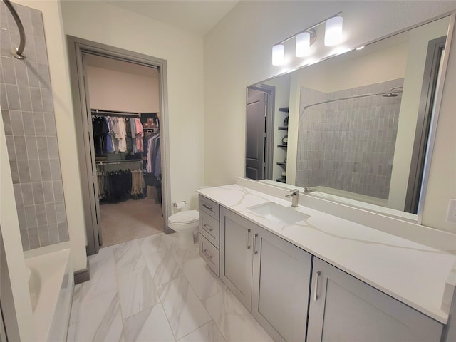bathroom with a tile shower, a walk in closet, vanity, toilet, and a bath