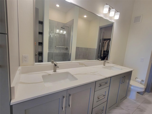 full bath featuring double vanity, visible vents, and a sink