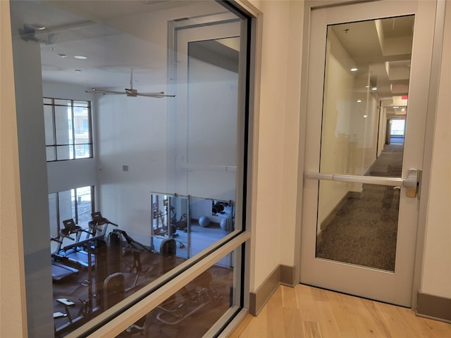 corridor with recessed lighting, plenty of natural light, and light wood finished floors