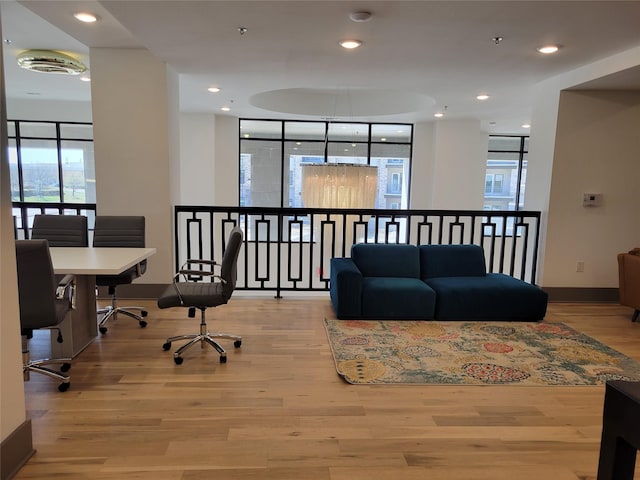 interior space featuring a healthy amount of sunlight, recessed lighting, and wood finished floors