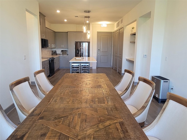 dining area with beverage cooler, recessed lighting, baseboards, a toaster, and dark wood-style floors