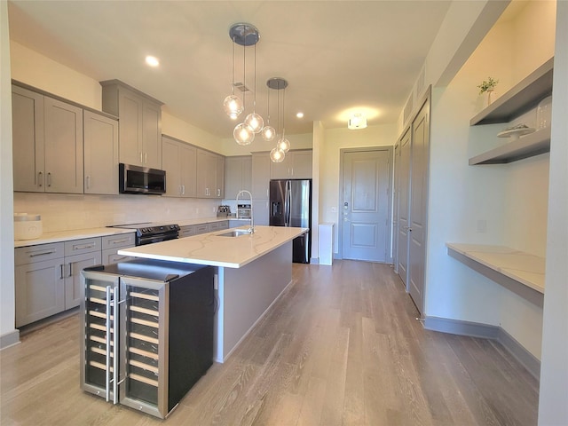 kitchen featuring open shelves, appliances with stainless steel finishes, light wood finished floors, gray cabinets, and tasteful backsplash