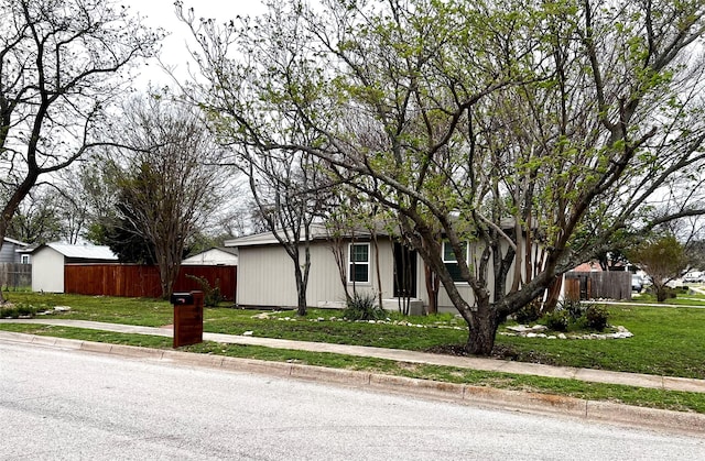 view of front facade featuring fence and a front yard