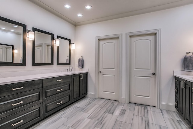 full bath featuring vanity, baseboards, and recessed lighting