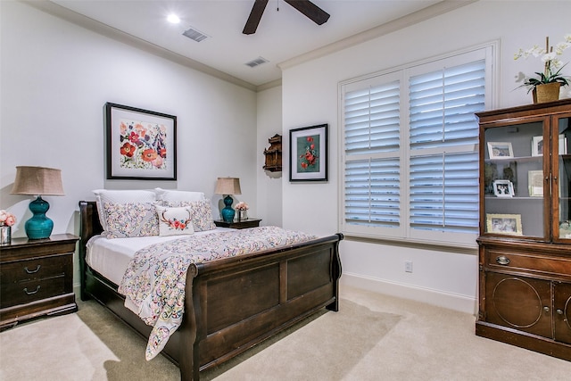 carpeted bedroom featuring visible vents, ornamental molding, baseboards, and ceiling fan