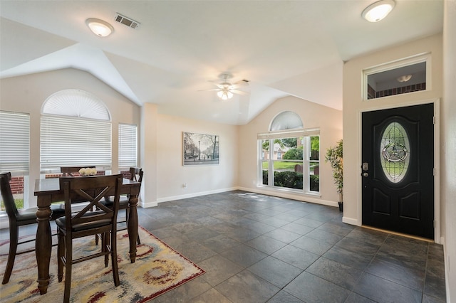 dining area featuring vaulted ceiling, a ceiling fan, baseboards, and dark stone finish floors