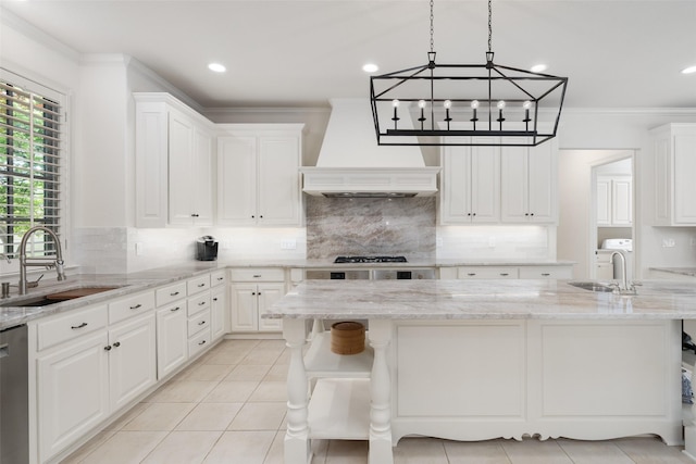 kitchen featuring white cabinetry, a sink, and tasteful backsplash