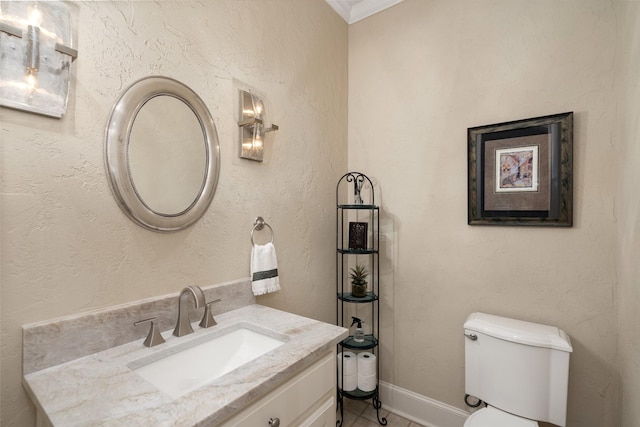 half bath featuring crown molding, toilet, baseboards, and vanity