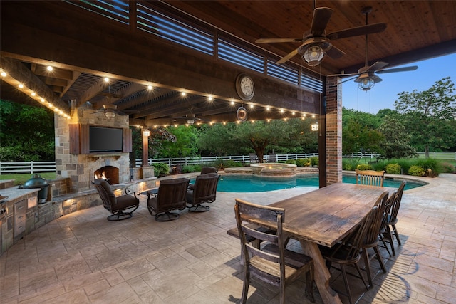view of patio with ceiling fan, a pool with connected hot tub, and fence private yard
