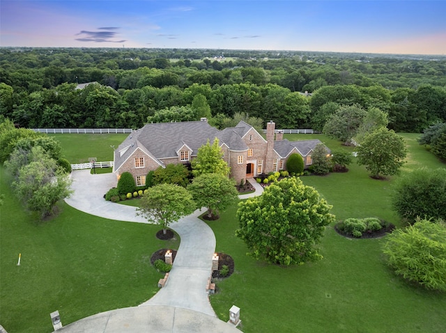 birds eye view of property with a wooded view