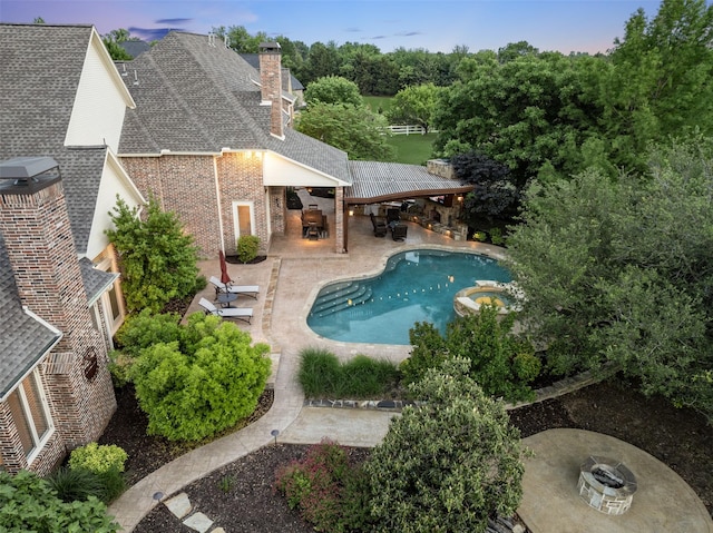 view of swimming pool with a gazebo, a patio area, a pool with connected hot tub, and an outdoor fire pit