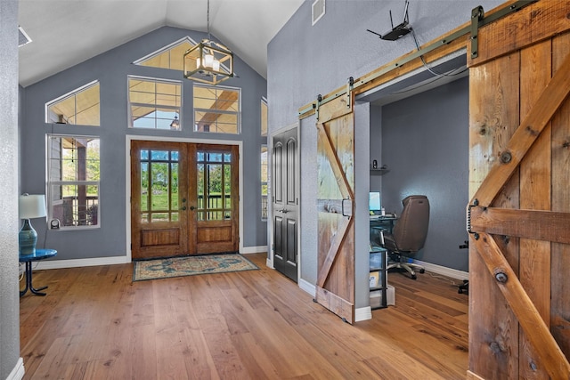 287 Vz County Road 3813, Wills Point, TX 75169 - foyer entrance with a barn door, wood finished floors, lofted ceiling, french doors, and baseboards