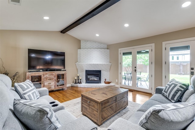 10907 Wonderland Trl, Dallas, TX 75229 - living room featuring a brick fireplace, lofted ceiling with beams, french doors, and light wood finished floors