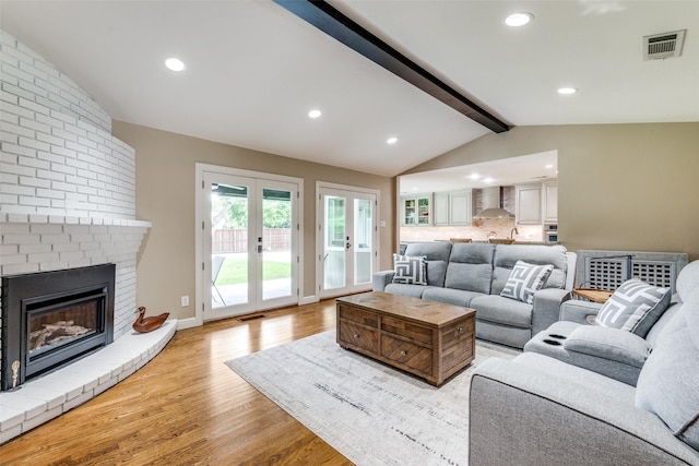 10907 Wonderland Trl, Dallas, TX 75229 - living area featuring visible vents, recessed lighting, french doors, lofted ceiling with beams, and light wood-style flooring