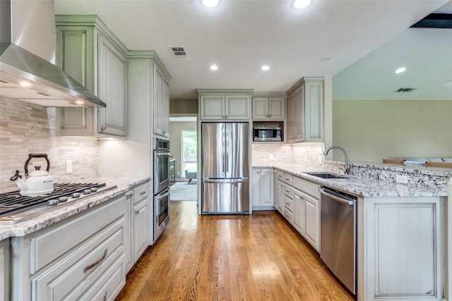 10907 Wonderland Trl, Dallas, TX 75229 - kitchen with wall chimney range hood, appliances with stainless steel finishes, a sink, and visible vents
