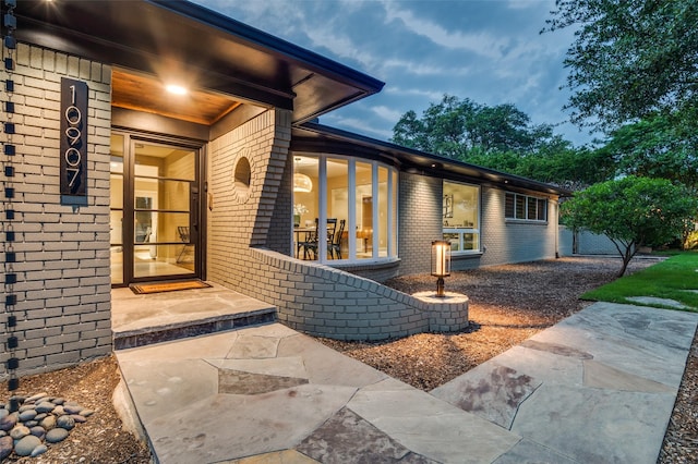 10907 Wonderland Trl, Dallas, TX 75229 - doorway to property featuring brick siding