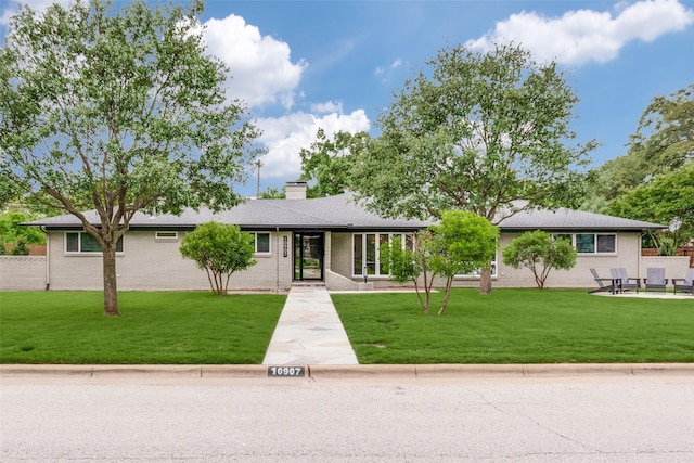 10907 Wonderland Trl, Dallas, TX 75229 - ranch-style house featuring a chimney, a front lawn, and brick siding