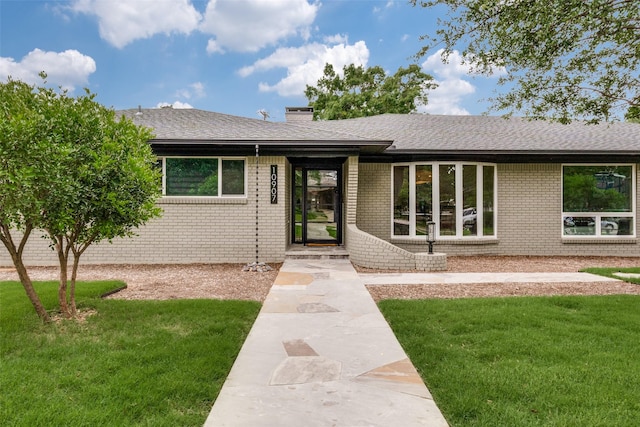 10907 Wonderland Trl, Dallas, TX 75229 - view of front of property featuring brick siding, a shingled roof, and a front yard