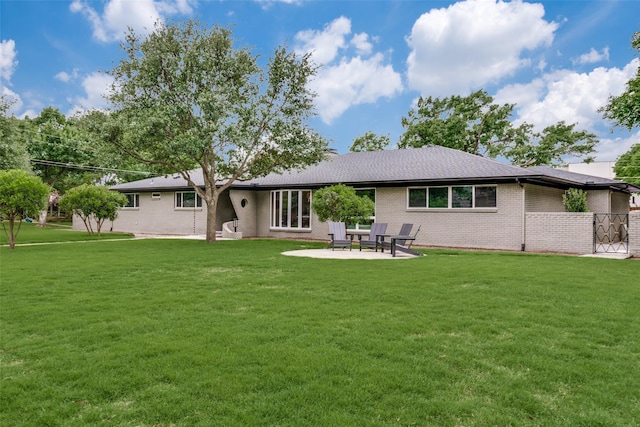 10907 Wonderland Trl, Dallas, TX 75229 - back of house with a lawn, brick siding, and a patio area