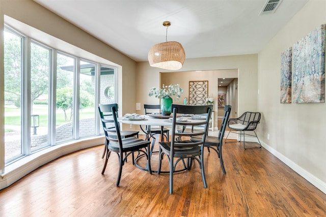 10907 Wonderland Trl, Dallas, TX 75229 - dining area with baseboards, visible vents, a healthy amount of sunlight, and wood finished floors