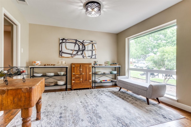 10907 Wonderland Trl, Dallas, TX 75229 - living area featuring baseboards, wood finished floors, and visible vents