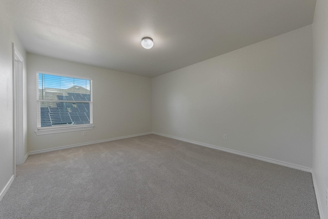 spare room with carpet floors and baseboards