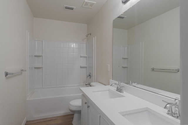 full bathroom with a sink, toilet, wood finished floors, and visible vents