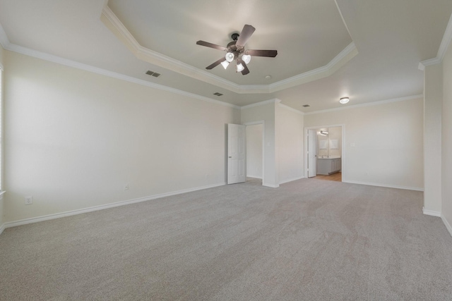unfurnished bedroom featuring visible vents, ornamental molding, carpet, and a tray ceiling