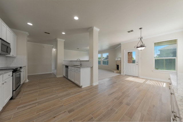kitchen with crown molding, backsplash, baseboards, and appliances with stainless steel finishes