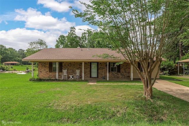single story home with covered porch, a front lawn, and brick siding