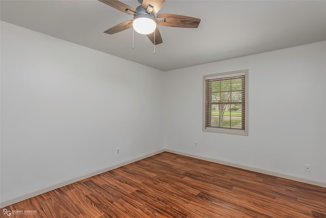 unfurnished room with baseboards, a ceiling fan, and wood finished floors