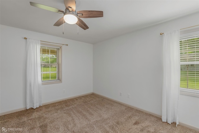 unfurnished room featuring baseboards, carpet, and a ceiling fan