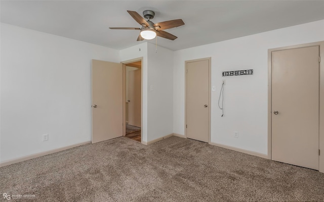 unfurnished bedroom featuring carpet floors, baseboards, and ceiling fan