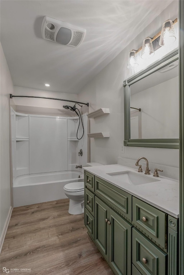 full bath with vanity, toilet, bathing tub / shower combination, wood finished floors, and visible vents