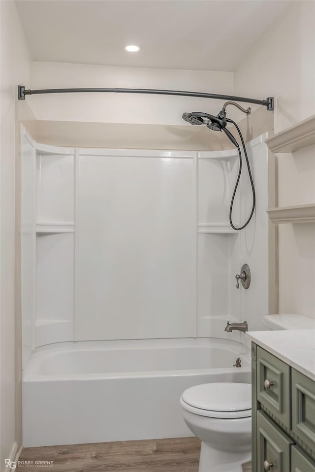 full bath featuring vanity, shower / bathtub combination, toilet, recessed lighting, and wood finished floors