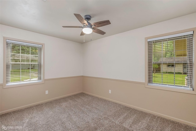 empty room featuring baseboards, ceiling fan, and carpet