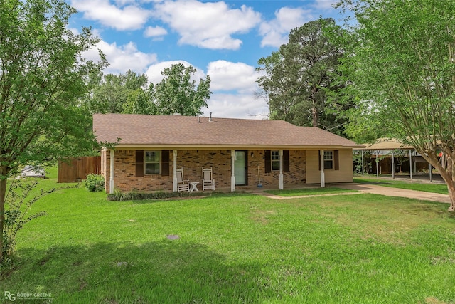 single story home with fence, covered porch, a front yard, brick siding, and driveway