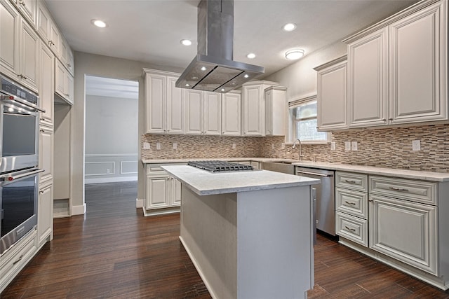 2620 Argyle Shore Dr, Rockwall, TX 75087 - kitchen featuring island range hood, dark wood-style floors, a sink, appliances with stainless steel finishes, and backsplash