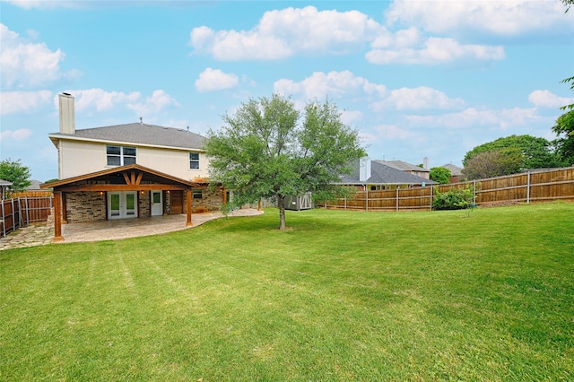 2620 Argyle Shore Dr, Rockwall, TX 75087 - view of yard featuring a patio, a fenced backyard, french doors, and a storage unit