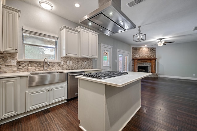 2620 Argyle Shore Dr, Rockwall, TX 75087 - kitchen featuring visible vents, a ceiling fan, wall chimney range hood, a sink, and appliances with stainless steel finishes