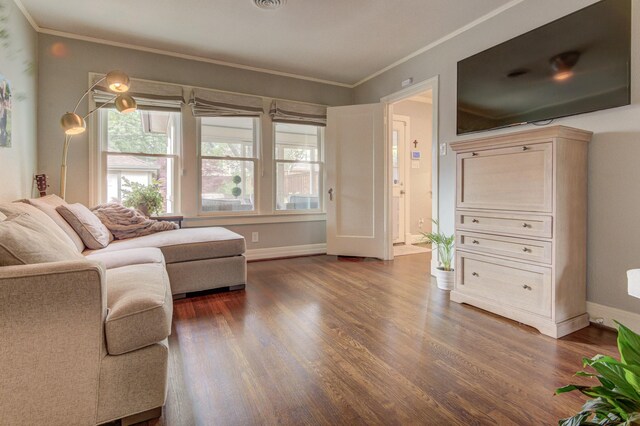 living area featuring crown molding, baseboards, and dark wood-style floors