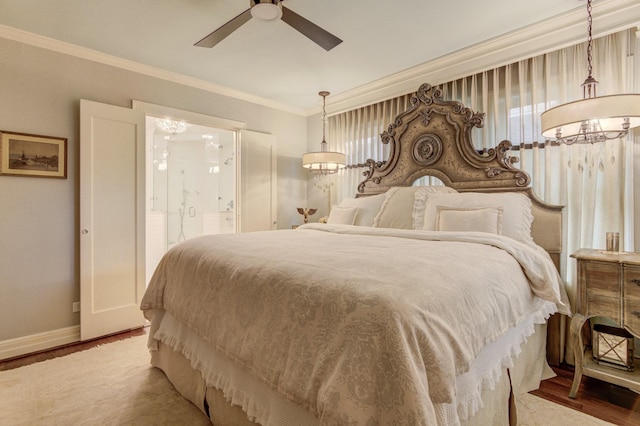 bedroom with a ceiling fan, baseboards, wood finished floors, ensuite bathroom, and ornamental molding