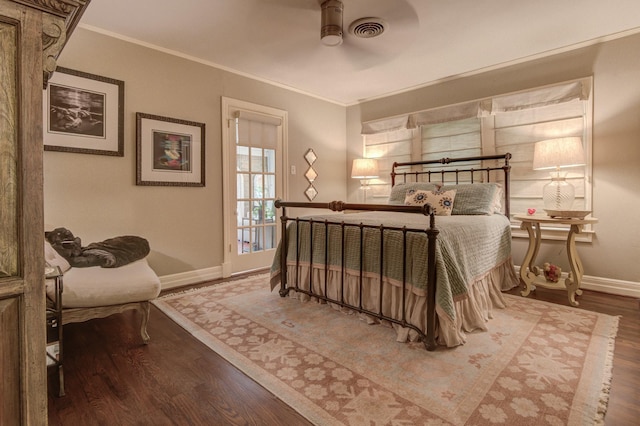 bedroom featuring baseboards, visible vents, ornamental molding, and wood finished floors